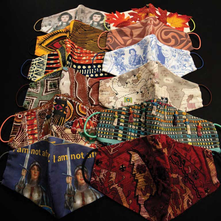 twelve face coverings are laid out on a table