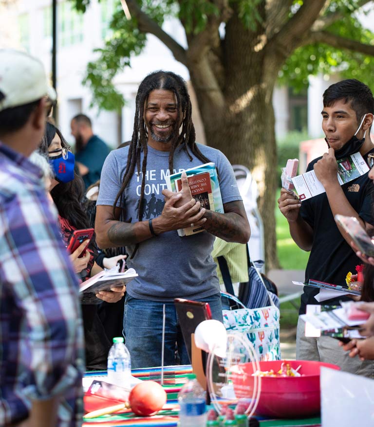 students socializing at a table at welcome back fair