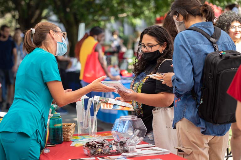 students interacting with nursing staff at welcome back fair