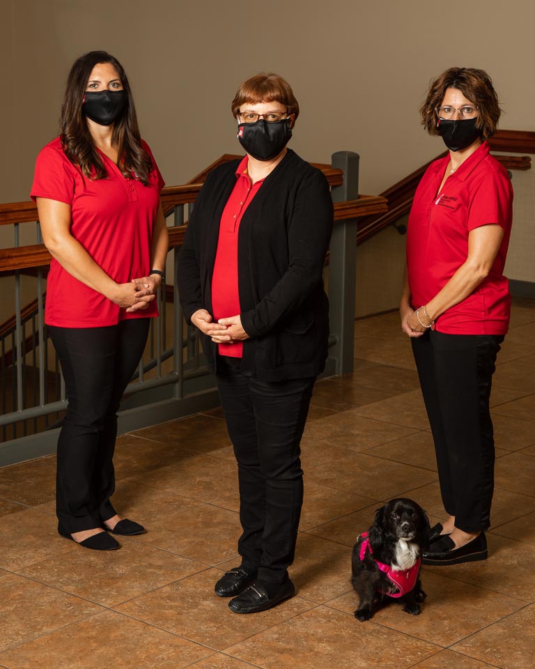 staff photo: Occupational Therapy faculty (l-r Allison Miller, Dr. Sharon Pape, and Dr. Denise Henderson) and therapy dog Maddie