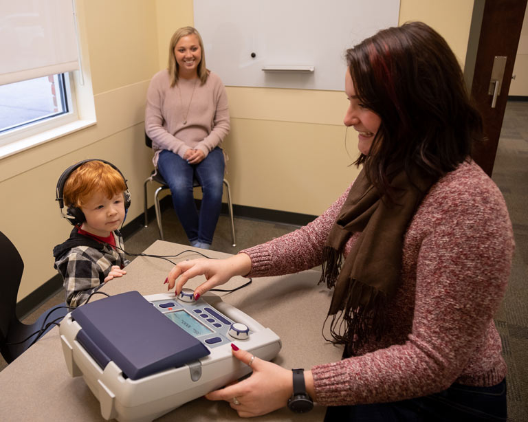 speech therapy students in session with child