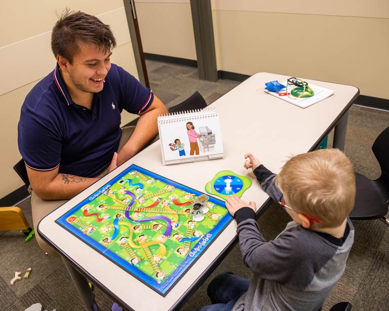 speech therapy student in session with child