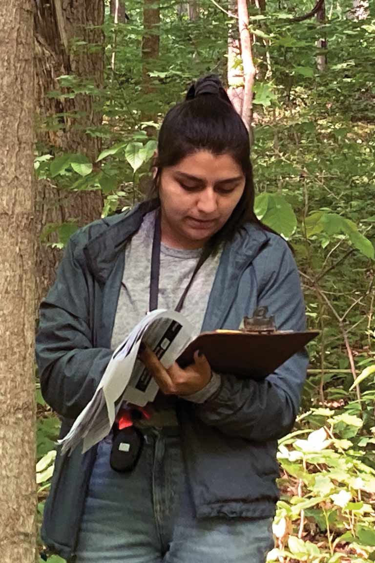 A student writing on a clipboard