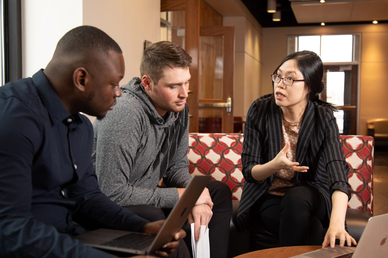 Huanan Xu talking with students